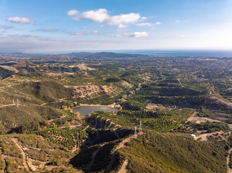The ranch and reservoir with the ocean on the horizon
